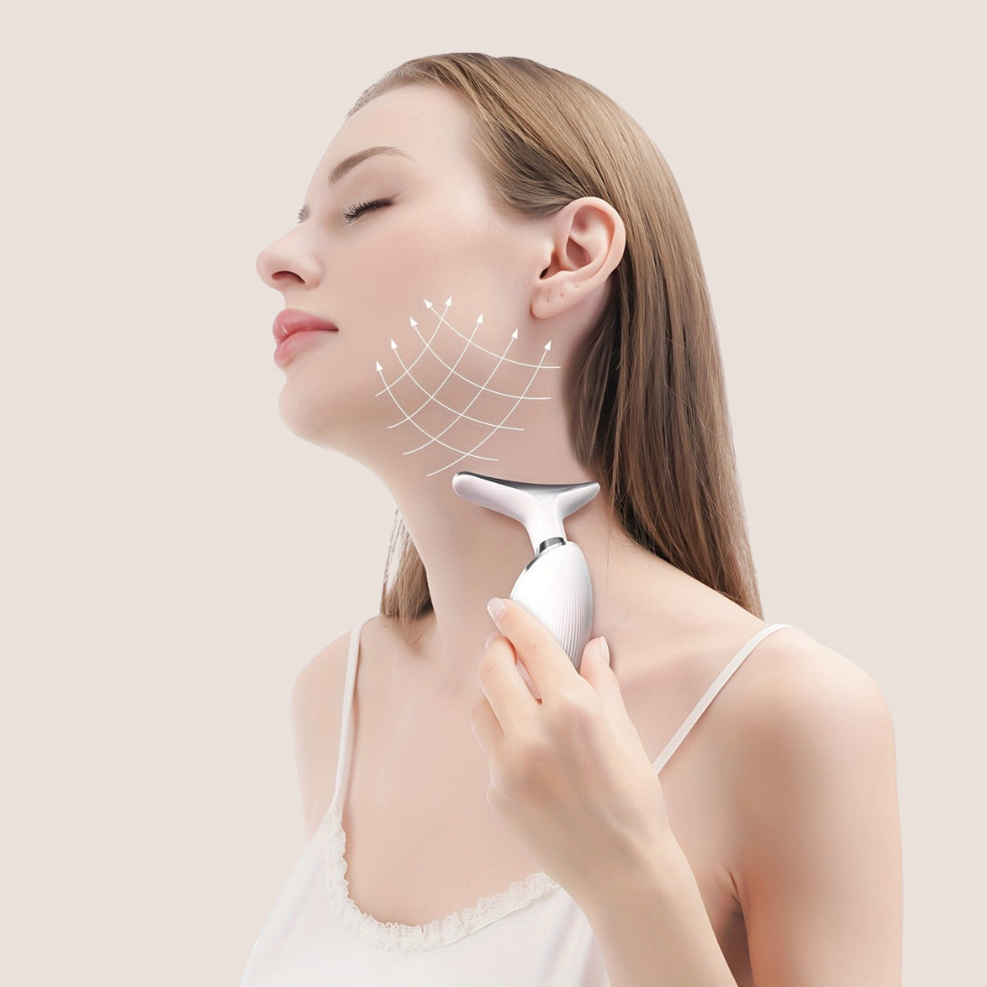 Woman using SkinRevive face and neck massager on the jawline to lift sagging skin and reduce tech neck lines.