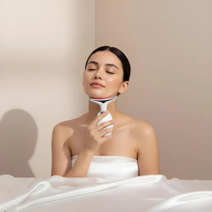 A relaxed woman using the Skin Revive red light LED neck massager to treat tech-neck wrinkles and stimulate collagen production.